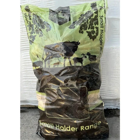 A lime green and dark brown plastic bag of economy wood briquettes 12kg with cattle goats and sheep silhouettes