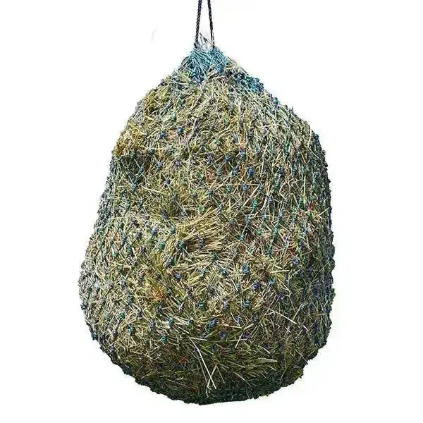 A hanging elico camborne haynet small holed haynet filled with green and brown hay and suspended by a black rope