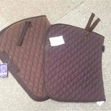 Brown elico cotton quilted saddlecloths with matching straps and rhinegold branded taped tag visible