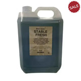 A 5-liter translucent plastic jug of elico stable fresh pine disinfectant with dark blue liquid and gold label stable fresh