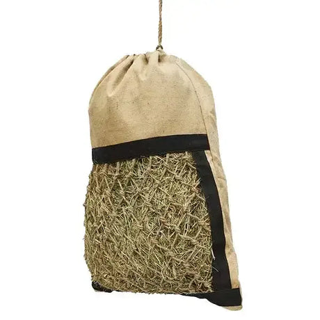 Beige elico hebden jute drawstring haybag with black trim and mesh section filled with golden straw for feeding hay