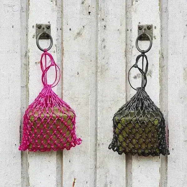 Two hanging mesh brick holders net in pink and dark green with knotted tops for elico little piggy fodder brick use