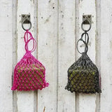 Two hanging mesh brick holders net in pink and dark green with knotted tops for elico little piggy fodder brick use