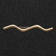 Gold-colored wavy metal elico wave stock pin with minimalist design perfect for riding apparel accessories