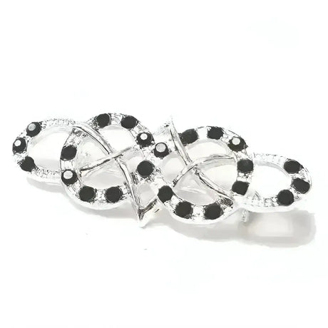 Silver equetech celtic stock pin with intricate interlocking celtic design adorned with black and clear gemstones