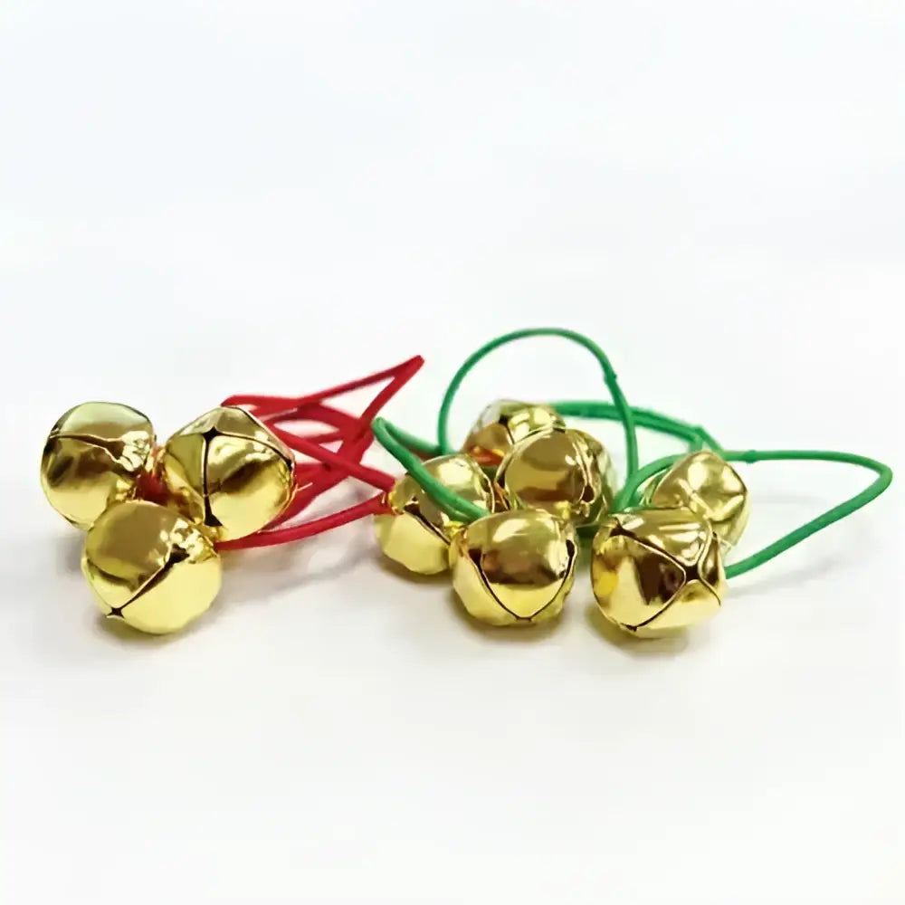 Golden jingle bells tied with red and green strings perfect for equetech christmas plaiting bands use