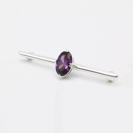 A sleek silver equetech deluxe amethyst stock pin with a central oval-cut purple amethyst stone