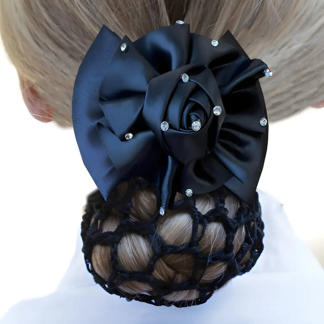 Elegant black fabric hair bow with rhinestones atop a braided bun for Dressage Rosette