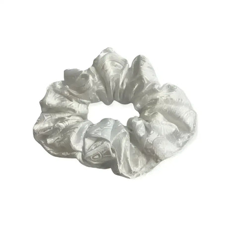 A shimmering silver satin equetech hair scrunchie with a subtle elegant paisley brocade pattern