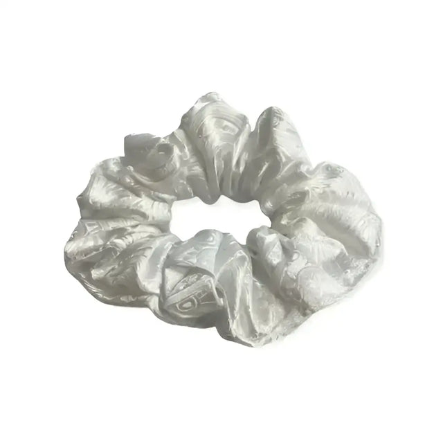 A shimmering silver satin equetech hair scrunchie with a subtle elegant paisley brocade pattern