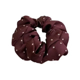 A maroon equetech hair scrunchie with small white polka dots jacquard hair accessory scrunchie pin spot