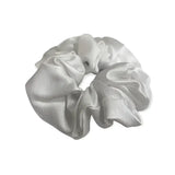 A shiny silver equetech hair scrunchie plain jacquard with a soft gathered satin texture perfect as a jacquard hair accessory