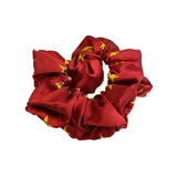 Red satin equetech hair scrunchie with gold star pattern elasticated hair accessory for stylish looks