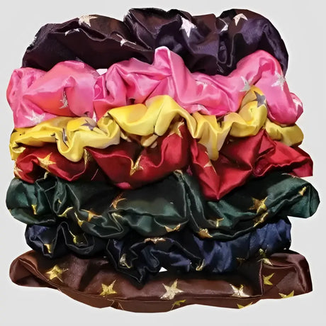 A stack of colorful satin equetech hair scrunchie stars with metallic gold thread elasticated hair accessory
