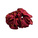 A maroon equetech hair scrunchies polka dot fabric scrunchie with small gold polka dots perfect for stylish hair styling