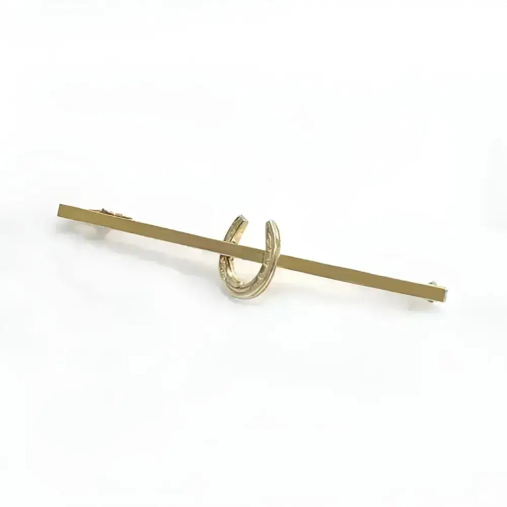 Gold-colored metal equetech horseshoe stock pin featuring a horseshoe stock pin design tie bar