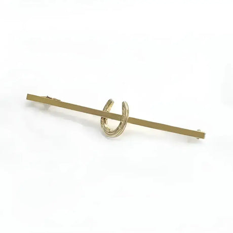 Gold-colored metal equetech horseshoe stock pin featuring a horseshoe stock pin design tie bar