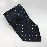 A navy blue silk equetech junior polka dot tie with small yellow dots perfect for junior polka dot ties fans