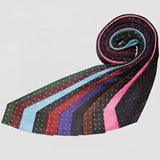 A rolled display of colorful equetech junior polka dot ties in black pink blue red and purple hues