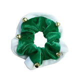 A festive green velvet christmas bells hair scrunchie with small gold bells perfect for holiday looks