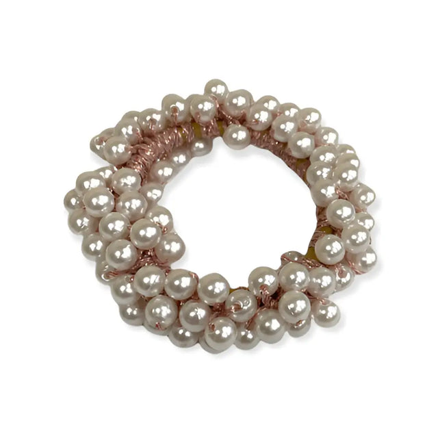 A delicate equetech pearl beaded scrunchie with multi-strand pearl cluster and soft pink woven band