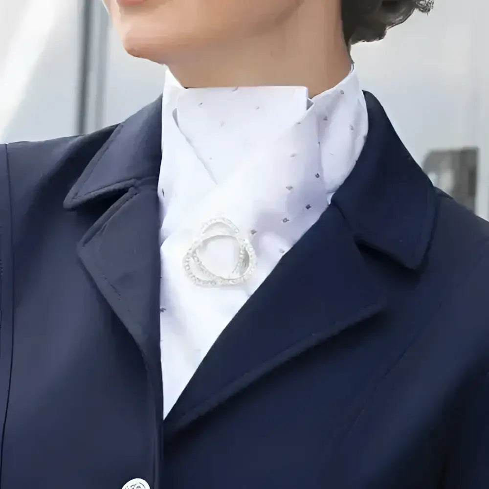Silver rhinestone stock pin with interlocking circles worn on navy blazer equetech ready-tied stocks accessory