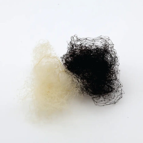 Two tangled fibrous hair bundles black and off white on white surface equetech invisible medium weight hairnets