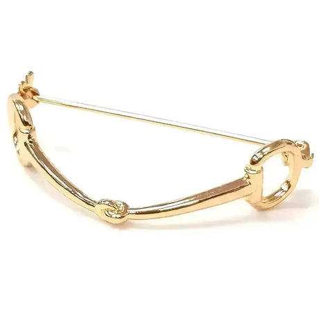 Gold-colored metal equetech snaffle stock pin with sleek polished finish and intricate horsebit detailing