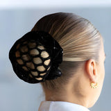 Elegant black mesh Equetech Solitaire Velvet Scrunchie over a blonde bun hairstyle