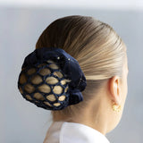 Navy blue sparkly hair net over a blonde bun with Equetech Solitaire Velvet Scrunchie