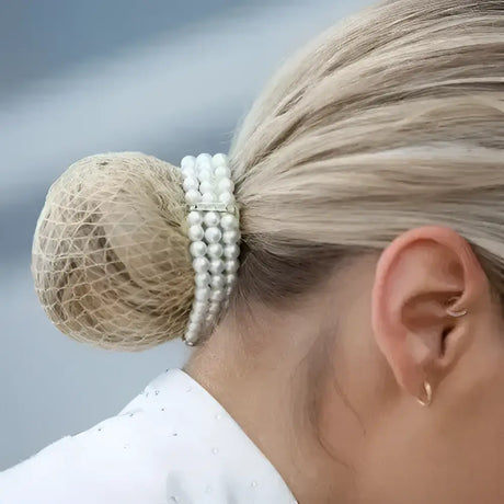 Equetech triple pearl bun ring scrunchie with silver clasp and three-strand pearls encircling blonde bun