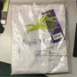 White equi theme ladies breeches velcro bottoms neatly folded in clear plastic with lime green ribbon packaging