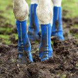 Blue equilibrium equi-chaps close contact chaps with yellow stitching covered in mud for mud fever prevention