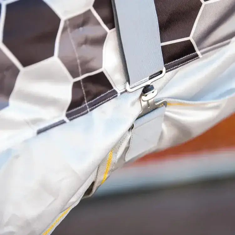 Gray hexagonal patterned equilibrium field relief fly rug with silver zipper and strap closure for easy use