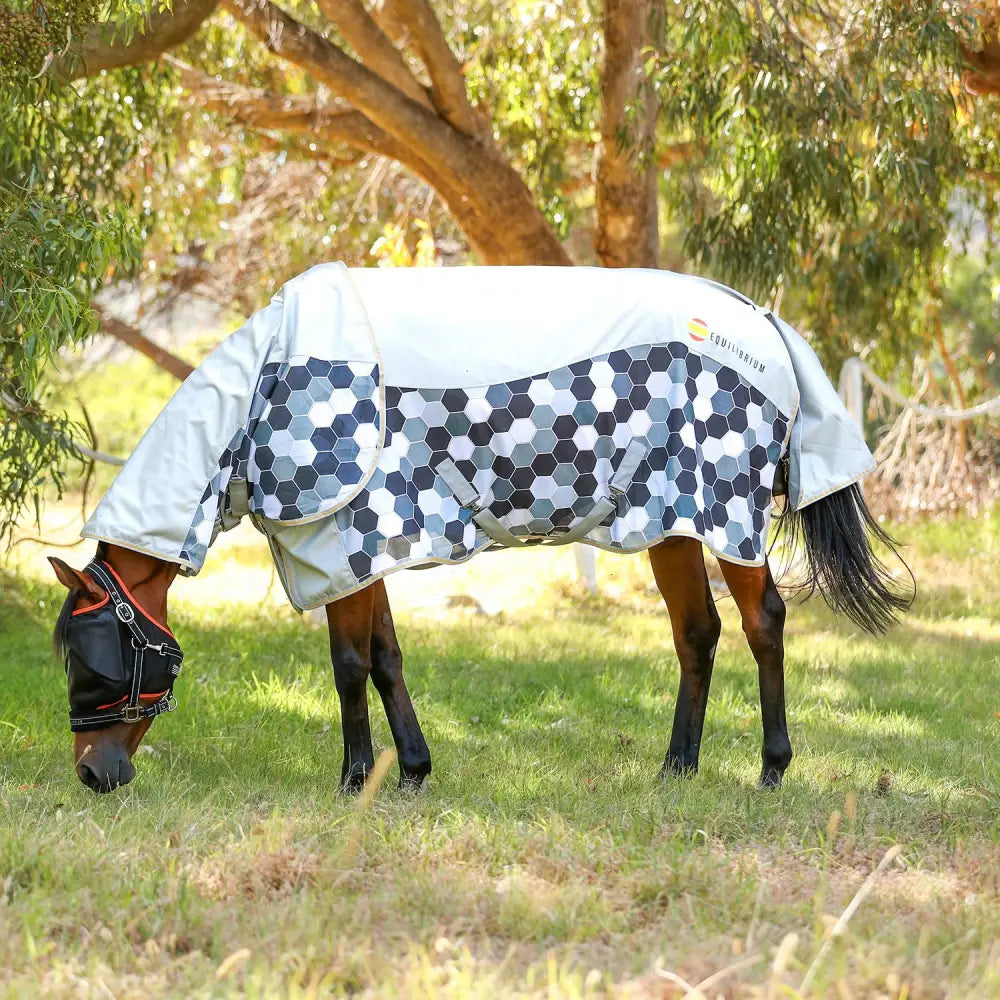 White and navy hexagonal equilibrium field relief waterproof fly rug designed for horse protection in the field