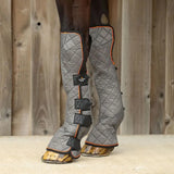 Gray quilted equilibrium fore and knee magnetic chaps with orange trim and black straps support mobility and healthy tendons