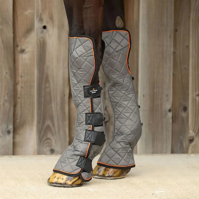 Equilibrium fore and knee magnetic chaps with gray quilted fabric orange trim and black straps support mobility and healthy tendons