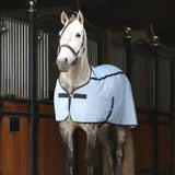 Light blue quick chill rug with black trim and adjustable straps designed for equestrian use by equilibrium quick chill
