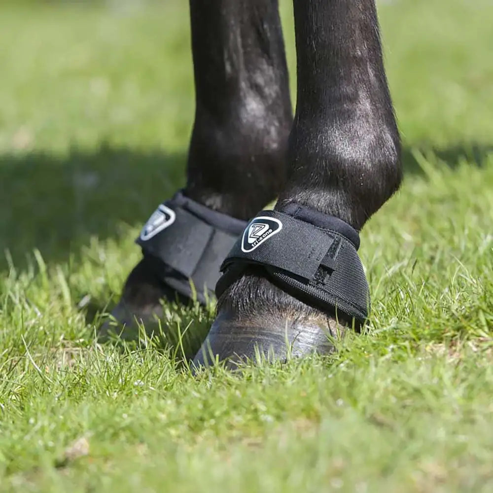 Black equilibrium tri-zone reach boots with white logo strap showing back side tested for overreach protection