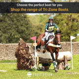 Brown horse wearing black equilibrium tri-zone reach boots mid-jump over log showing reach boots tested durability
