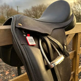 Black leather english saddle with silver stirrups and a red equine emergency tag endurotag emergency tag attached