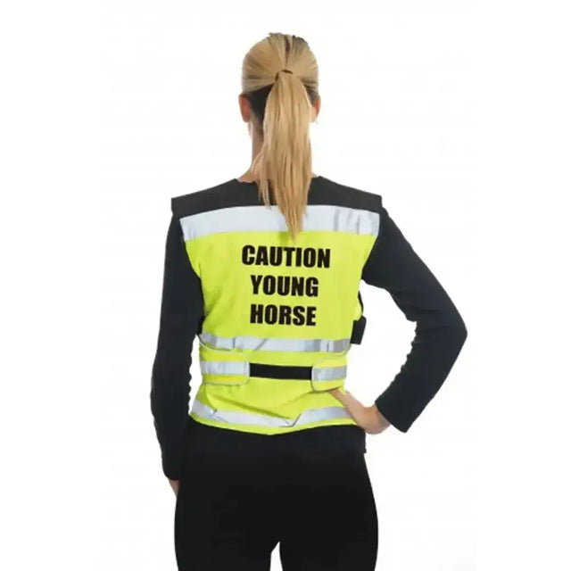 Bright yellow equisafety air waistcoat caution young horse yellow with reflective stripes worn over black shirt