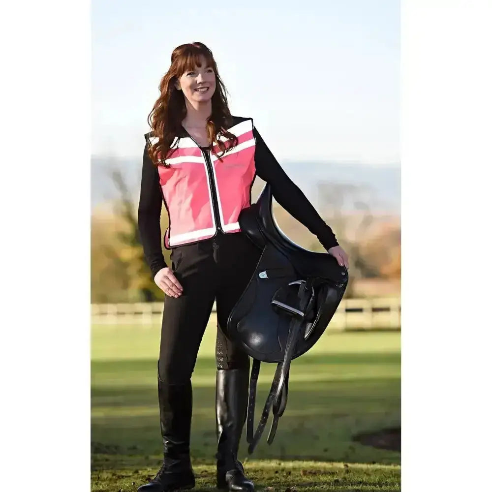 Black leather equestrian saddle with silver hardware paired with equisafety hi viz waistcoat plain air for riding safety