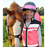 Child wearing a pink and white reflective equisafety hi viz waistcoat plain air with black trim