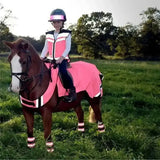 Pink reflective winter exercise rug with white stripes and matching leg wraps made from performance fabric