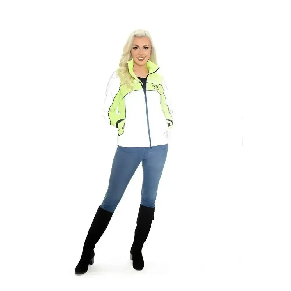 A woman wearing an equisafety mercury lightweight reflective riding coat in white and neon green with black trim