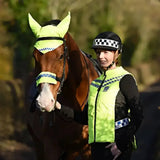 A woman and horse wearing bright neon yellow equisafety polite hat and reflective polite hat band for safety visibility