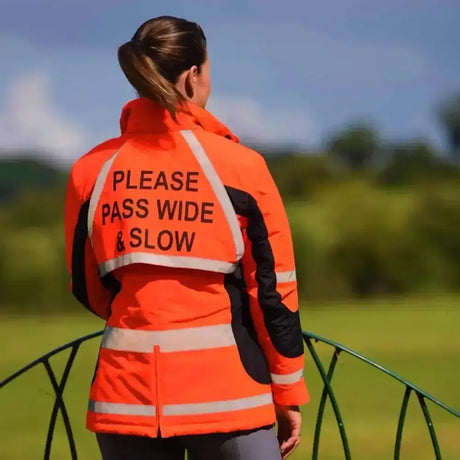 Back of equisafety winter inverno riding jacket red with bright orange high visibility and please pass wide and slow text
