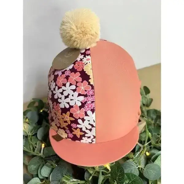 A coral terracotta hat cover with equisilks spring floral ditsy floral design and a beige pom-pom on top
