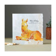 Fanciful dolomite card featuring a golden foal with white markings on textured paper saying new baby perfect for happy anniversary